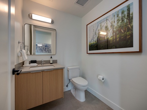 Freshen up in your stylish bathroom, where clean lines and warm wood tones create a serene retreat after your mountain adventures.