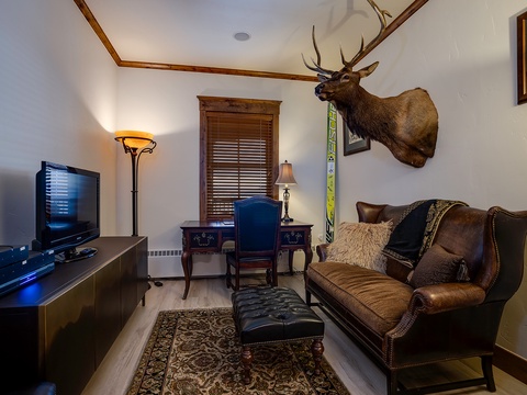 Sink into rich leather seating in your private lounge, complete with a flatscreen TV, warm lighting, and rustic character that invites you to truly unwind after a day of adventure.