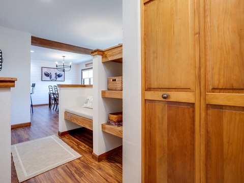 Step inside to discover warm wood tones and thoughtful built-in storage throughout, creating a welcoming and organized retreat where everything has its place.