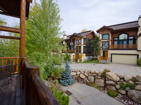 This mountain retreat features custom timber-frame architecture and natural stone landscaping, set in a quiet, tree-lined neighborhood with scenic surroundings.