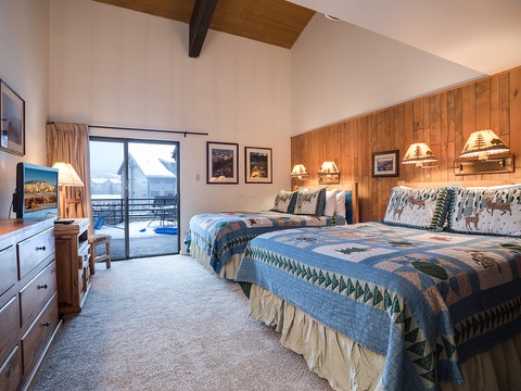 Slip into cozy beds with rustic warmth, vaulted ceilings, and mountain charm. Your balcony access opens to snowy serenity—perfect for a restful alpine escape.