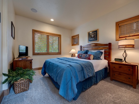 Sink into plush bedding and soft lighting in your restful bedroom retreat, where warm wood tones and thoughtful touches create the perfect space to unwind after exploring.