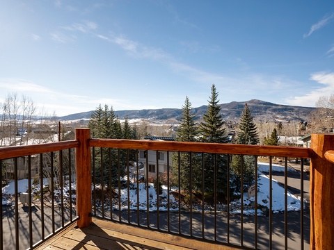 The property offers expansive mountain vistas and a peaceful valley setting, surrounded by winter scenery and evergreen forests that define the local landscape.