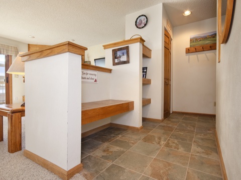This bright entryway offers built-in benches and custom shelving for your gear, a spacious mudroom for easy arrivals after a day of adventure.