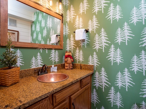 Refresh in your charming woodland-themed bathroom with forest-green walls, copper sink, and cozy cabin details that bring nature indoors for a truly peaceful escape.