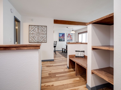 Step into your mountain retreat with warm wood accents, custom shelving, and local artwork welcoming you to unwind and make yourself at home.