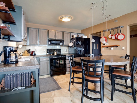 Your fully equipped kitchen awaits with gleaming appliances, granite counters, and a breakfast bar where you can share morning coffee or plan the day's adventures together.