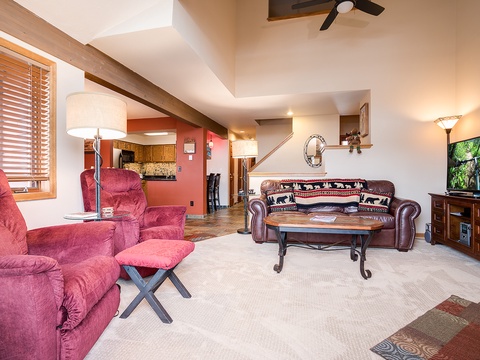 Settle into this spacious living room with vaulted ceilings, rustic beams, and plush seating. Unwind with your favorite shows on the large TV, or simply soak in the warm ambiance of your mountain retreat.
