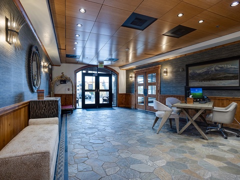 Step into a welcoming lobby where rustic wood accents meet contemporary design. Relax in the inviting seating area or catch up on work at the convenient desk—your mountain retreat starts here.