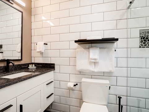 Crisp white subway tile and elegant granite create a spa-like retreat where you can unwind and refresh in comfort and style.