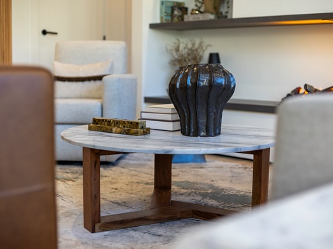 Sink into plush seating and admire the thoughtful design—a marble coffee table anchors your lounge, surrounded by elegant touches that make unwinding effortless.
