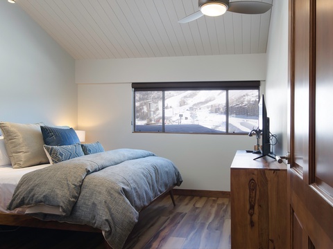Drift off in your cozy bedroom with stunning ski slope views right from your window, blending comfort with mountain magic.