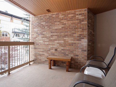 Step onto your private covered balcony, where comfortable lounge chairs await. Relax with your morning coffee or evening drink while taking in the peaceful neighborhood views.
