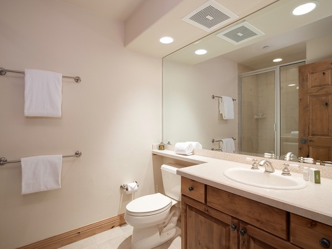 Your private bathroom features a spacious vanity, fresh towels, and a walk-in shower—everything you need to refresh after a day of adventure.