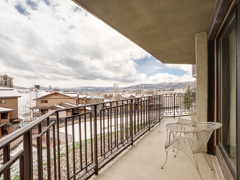 A scenic mountain-resort community stretches below your private balcony, offering a serene backdrop for morning coffee or evening relaxation in the fresh alpine air.