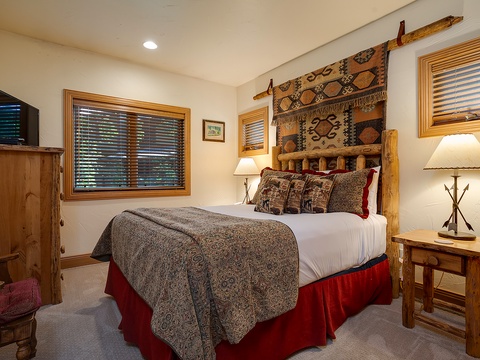 Sink into crisp linens and rustic mountain charm in your cozy bedroom, complete with warm wood furnishings, plush bedding, and thoughtful touches that invite restful nights after adventure-filled days.