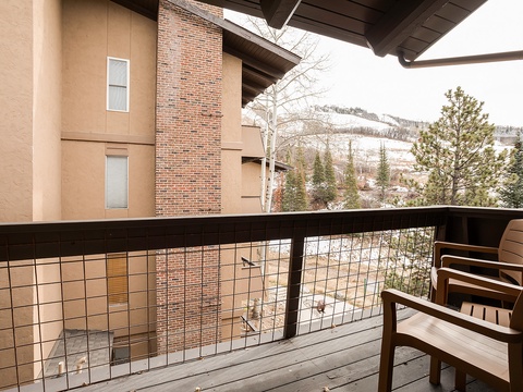 Your private balcony overlooks snow-dusted peaks and evergreen trees—a peaceful mountain retreat where morning coffee or evening relaxation feels perfectly serene.