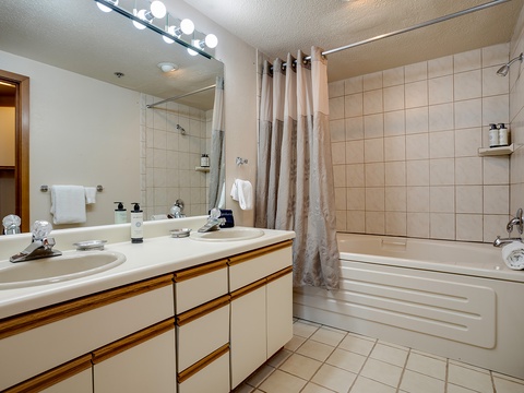Your private bathroom offers a spacious vanity, fresh towels, a soothing tub-shower combo, and thoughtful amenities to help you unwind after a day exploring.
