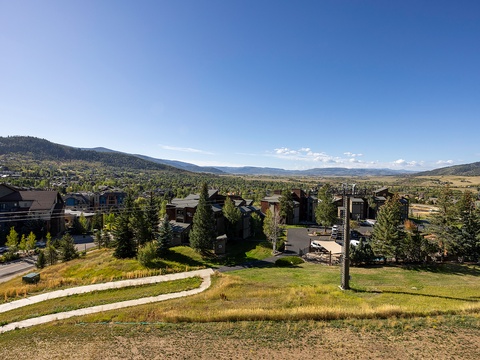 A peaceful mountain community nestled in a scenic valley, surrounded by rolling hills and natural beauty.