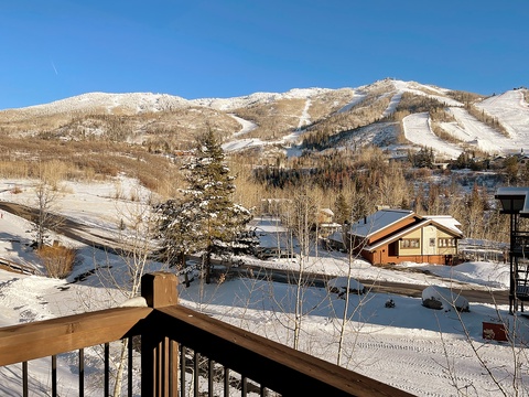 Snow-covered mountains with ski runs surround this vacation rental area. The property offers convenient access to winter sports and mountain scenery during the snowy season.