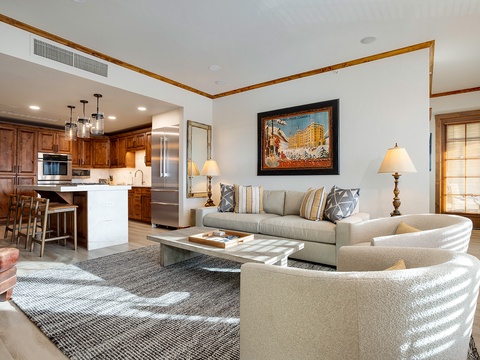 Relax in your spacious, open living area with plush seating and a fully equipped kitchen at your fingertips. Natural light, refined wood accents, and stylish decor create a welcoming mountain retreat where you can truly unwind.