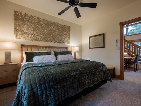 Sink into plush bedding and unwind in your serene bedroom, where natural wood tones and soft lighting create a warm, restful ambiance perfect for recharging after a day of adventure.