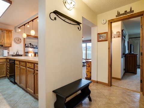 Step into your mountain retreat, where warm wood tones and thoughtful touches invite you to settle in. The bright kitchen awaits your morning coffee, while cozy rooms beckon beyond.