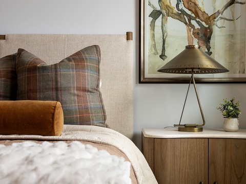 Sink into your cozy bed, surrounded by warm earth tones, thoughtful art, and soft lighting—your peaceful retreat awaits after a day of adventure.