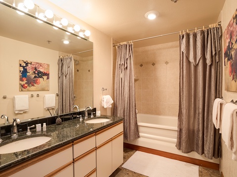 Refresh in your private bathroom featuring a full tub-shower combo, elegant granite countertops, and plush towels waiting for you.