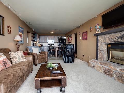 Your cozy retreat awaits with plush seating, a warm stone fireplace, and a fully equipped kitchen—perfect for unwinding after your mountain adventures.