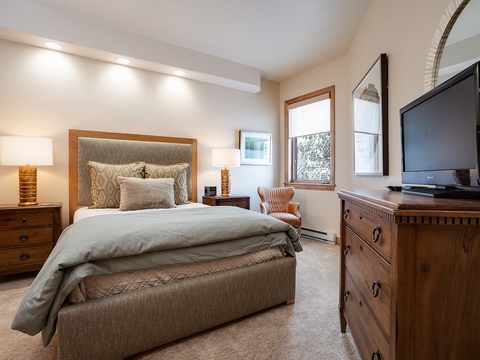 Drift off in your plush bed with textured linens, warm lighting, and mountain views framed by your window. Entertainment and comfort merge effortlessly here.