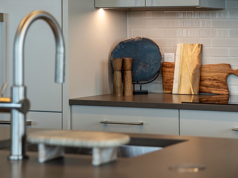 Picture yourself preparing a meal in this elegant, fully equipped kitchen with sleek counters and modern finishes. Warm wood accents and stylish details invite your inner chef to create memorable vacation dishes.