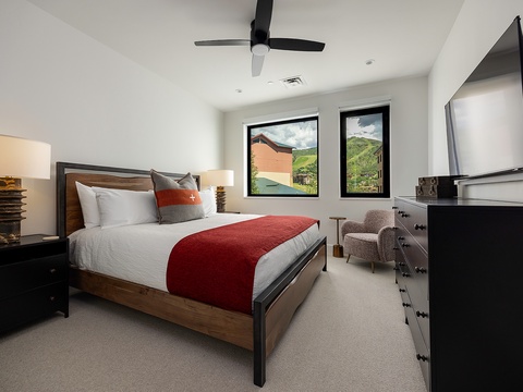 Settle into your restful bedroom with mountain views framed by sleek windows, cozy linens, and a peaceful palette that welcomes you after a day of adventure.