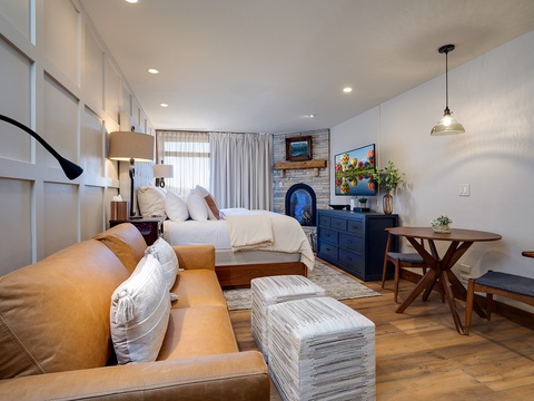 Sink into the plush leather sofa and unwind by your own cozy fireplace, surrounded by thoughtful details—crisp linens, warm wood tones, and charming coastal artwork—all designed for your comfort and relaxation.