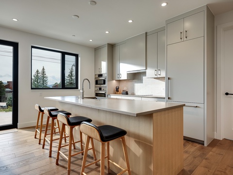 You'll love whipping up meals in this bright, modern kitchen with sleek countertops, ample storage, and a spacious island perfect for morning coffee or gathering with friends.