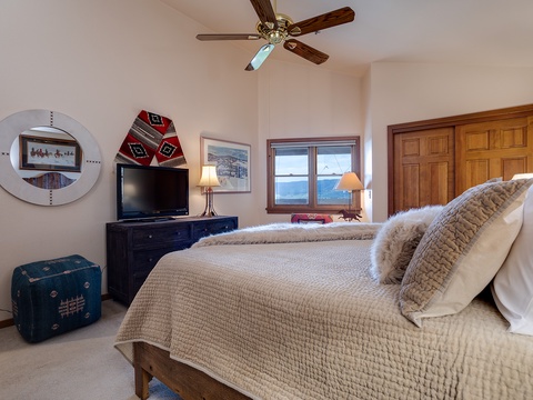 Sink into plush bedding and unwind in your peaceful bedroom, where a ceiling fan keeps you cool and your window frames stunning water views. Personal touches make this your own retreat.