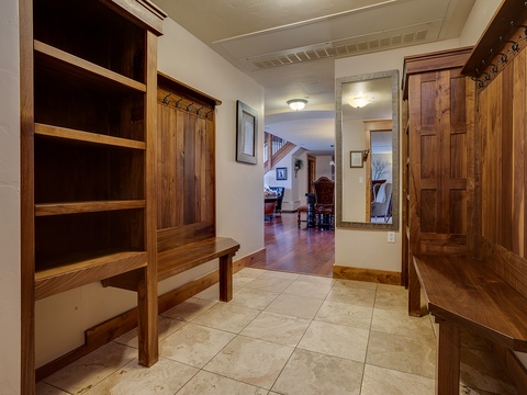 Step into your welcoming entryway with warm wood accents, built-in storage, and a cozy bench—perfect for settling in after a day of adventure.