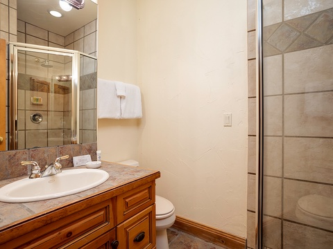 Fresh towels await on the countertop, and your private glass-enclosed shower invites a refreshing start to each mountain day.