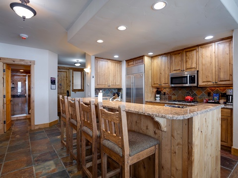 Your mountain retreat awaits with a chef-worthy kitchen featuring granite counters, stainless appliances, and a welcoming breakfast bar—perfect for gathering after your adventures.