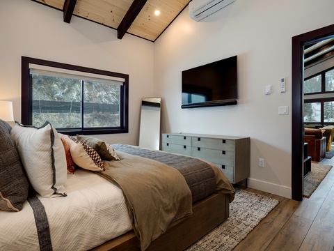 Sink into plush linens and wake to mountain views framed by your window. The vaulted ceiling and modern touches create your perfect alpine retreat.
