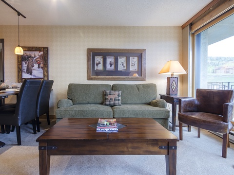 Relax in your cozy living room with mountain views, plush seating, and warm lighting—perfect for unwinding after a day of adventure.