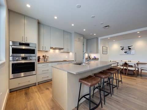 Your sleek, modern kitchen awaits with stainless steel appliances, a spacious island for morning coffee, and an open flow into the dining area—perfect for gathering with loved ones.