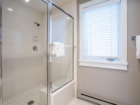 Step into your sparkling clean bathroom featuring a walk-in shower with fresh towels waiting for you. Natural light and modern finishes create a bright, refreshing space to start your day.