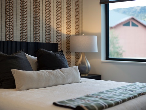 Unwind in your peaceful retreat, where crisp linens and thoughtful textures invite you to relax. Step outside to take in the serene neighborhood scenery framed by your window.