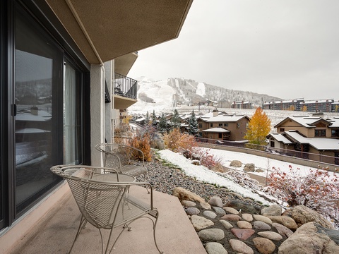 Sip your morning coffee on your private balcony and soak in stunning mountain views framed by autumn foliage and fresh snow—a peaceful escape with ski slopes just beyond the rooftops.