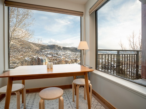 A quiet corner framed by sweeping mountain and town views—perfect for morning coffee or planning your next adventure in the snowy peaks beyond.