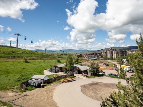 Aerial view of the mountain resort area showing gondola access, surrounding development, and panoramic valley landscape framing the property's location.