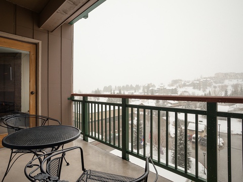 Step out onto your private balcony and enjoy serene winter views of snowy hills and evergreens. Cozy up at the bistro table with your morning coffee, breathing in crisp mountain air.