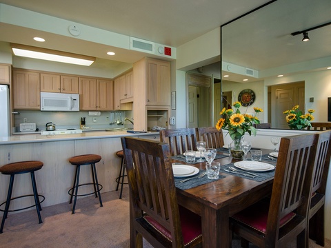 Gather around the dining table for memorable meals, with a fully equipped kitchen at your fingertips and sunflowers adding a cheerful touch to your stay.