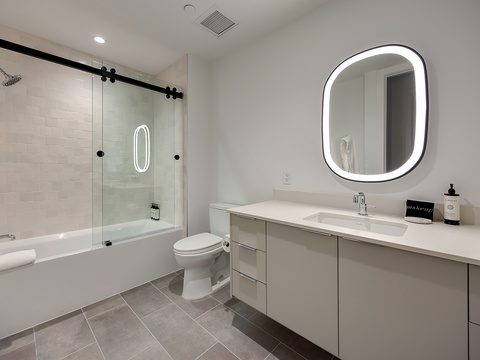 Refresh in your sleek modern bathroom with a spacious soaking tub, rainfall shower, and beautiful vanity lighting—everything you need to unwind after exploring.